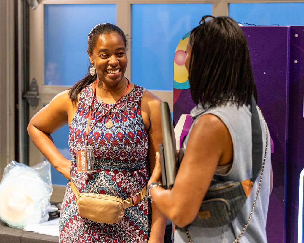 Attendees laughing together at Rooted & Rising